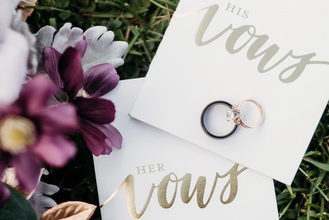 Bouquet and wedding rings on vow book
