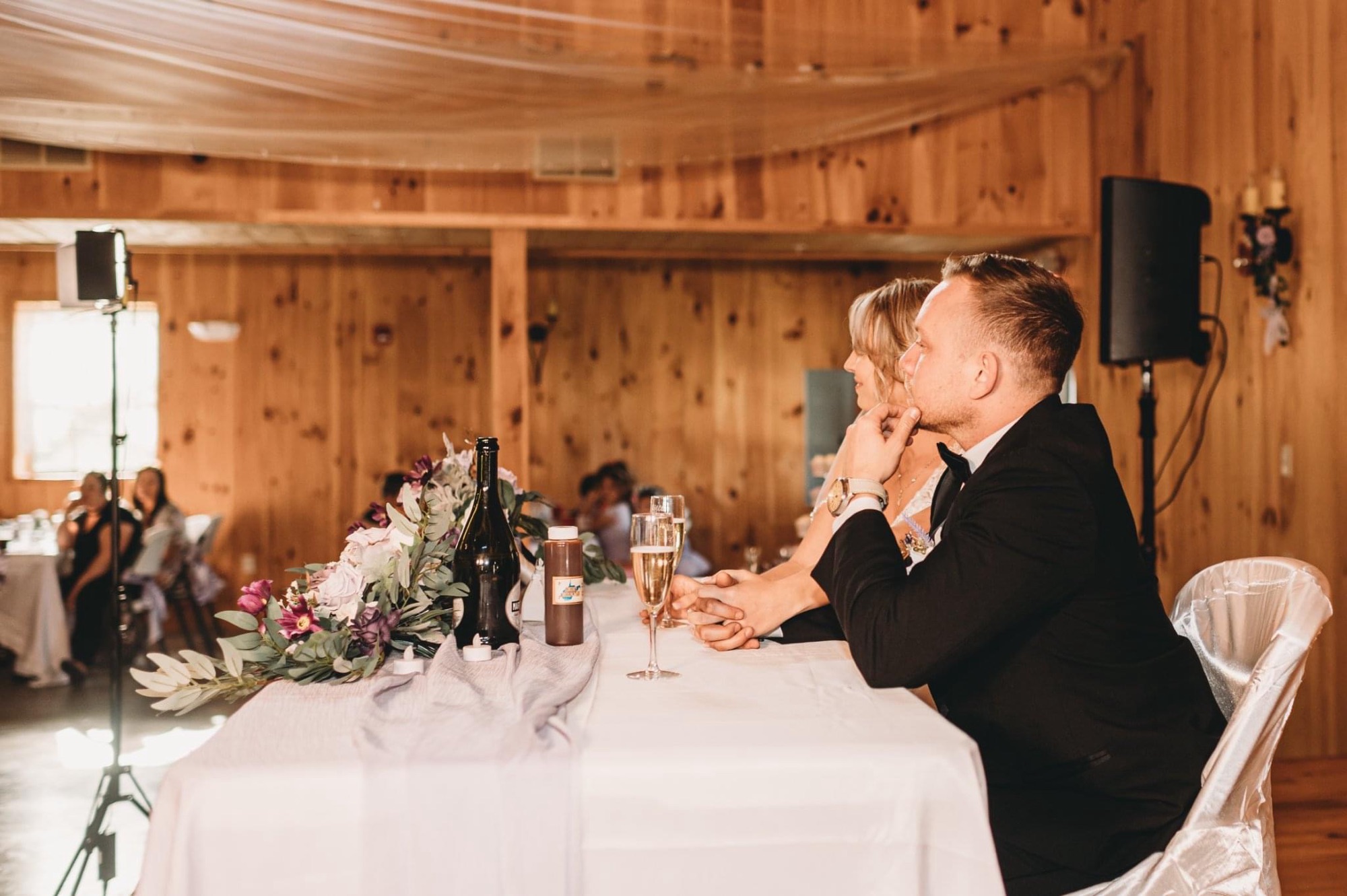 Bride and groom sweetheart table overlooking wedding guests