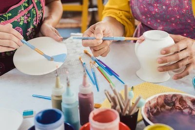 Guests painting pottery at a bridal shower in Western Maryland