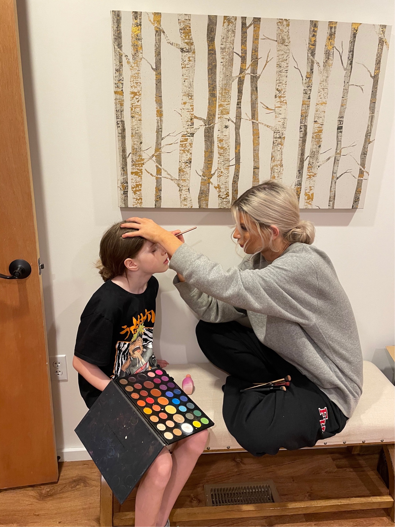 Bridesmaids helping with hair and makeup on wedding morning