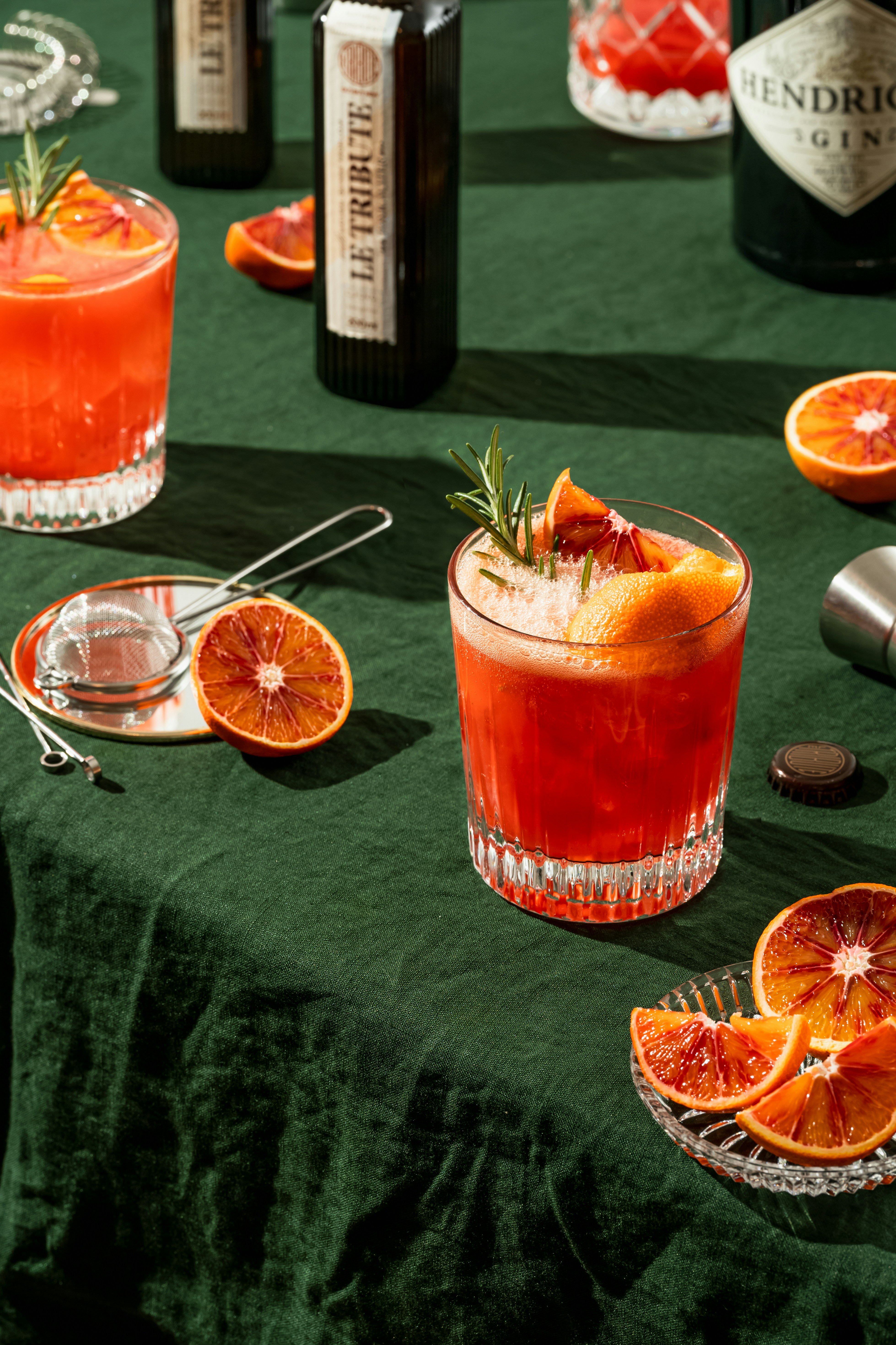 Blood orange fall wedding cocktail with rosemary garnish